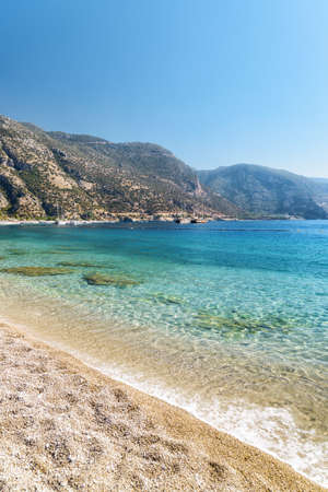 View of wonderful clear water of the Mediterranean Sea from Oludeniz Beach in Turkey. Scenic mountains are visible in background. Oludeniz is a popular tourist attraction in Turkey.の写真素材