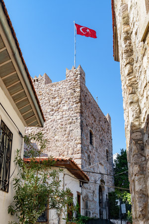 Scenic view of the Turkish flag fluttering over the Marmaris Castle in Turkey. Marmaris is a popular tourist destination in the Turkish Riviera.のeditorial素材