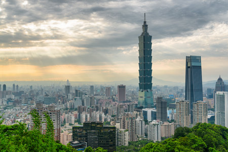 Awesome view of Taipei from top of mountain at sunset, Taiwan. Skyscrapers and other modern buildings of downtown. Amazing cityscape. Taipei is a popular tourist destination of Asia.の写真素材