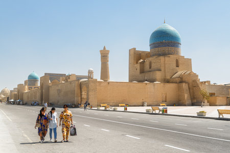 Bukhara, Uzbekistan - September 4, 2022: Unusual view of Po-i-Kalan complex in Historic Center of Bukhara. Awesome dome of the Kalan Mosque and the Kalan Minaret are visible on blue sky background.のeditorial素材
