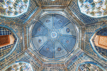 View of ceiling in the Shah-i-Zinda Ensemble in Samarkand, Uzbekistan. Ceiling decorated by blue tiles with designs. The necropolis is a popular tourist attraction of Central Asia.のeditorial素材