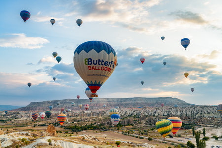Cappadocia, Turkey - September 22, 2021: Awesome view of colorful hot air balloons flying over Goreme Historical National Park. Fabulous landscape of Cappadocia, Turkey.のeditorial素材