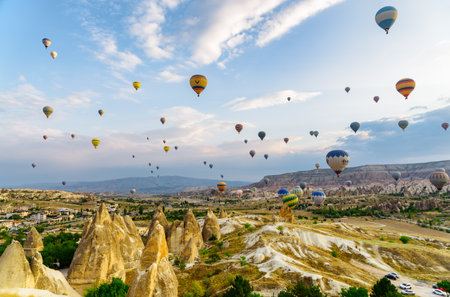 Cappadocia, Turkey - September 22, 2021: Awesome view of colorful hot air balloons flying over Goreme Historical National Park. Fabulous landscape of Cappadocia, Turkey.のeditorial素材