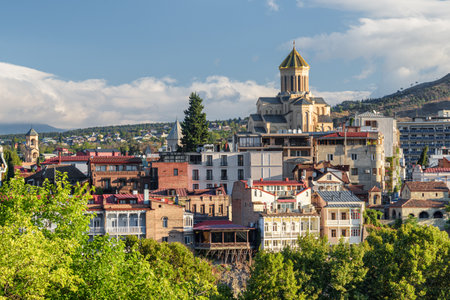 Awesome city view of Tbilisi, Georgia. The Holy Trinity Cathedral of Tbilisi (Sameba) is visible on blue sky background. The Sameba Cathedral is a popular tourist attraction of the Caucasus region.の写真素材