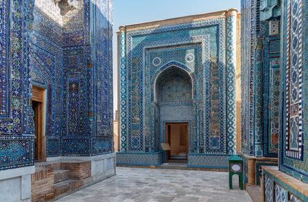 Awesome view of the upper group of mausoleums at the Shah-i-Zinda Ensemble in Samarkand, Uzbekistan. Mausoleums decorated by blue tiles with designs are a popular tourist attraction of Central Asia.の写真素材