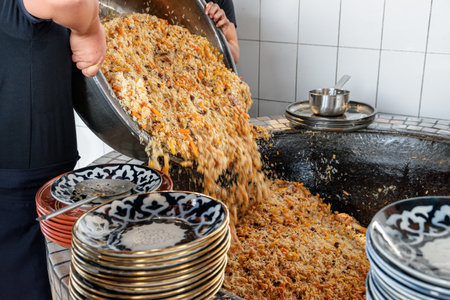 Fresh cooked wedding Uzbek plov in Tashkent, Uzbekistan. The signature dish of Uzbekistan is cooked with rice, meat, carrots and onions. Pilaf is a traditional food at Central Asia.の写真素材