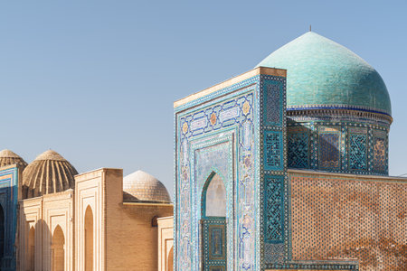 Awesome view of the Shah-i-Zinda Ensemble in Samarkand, Uzbekistan. Mausoleums decorated by blue tiles with designs. The necropolis is a popular tourist attraction of Central Asia.の写真素材