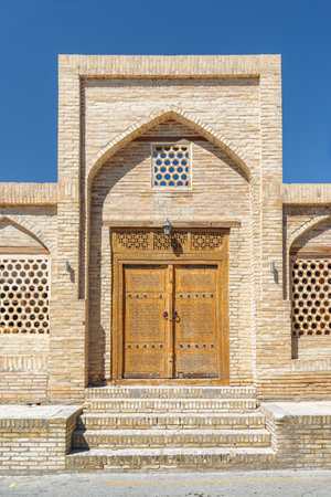 Scenic entrance to Caravanserai Ahmadjon in Historic Center of Bukhara, Uzbekistan. The ancient town is a popular tourist attraction of Central Asia.の写真素材
