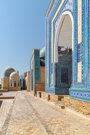 Awesome view of the Shah-i-Zinda Ensemble in Samarkand, Uzbekistan. Mausoleums decorated by blue tiles with designs. The necropolis is a popular tourist attraction of Central Asia.の写真素材