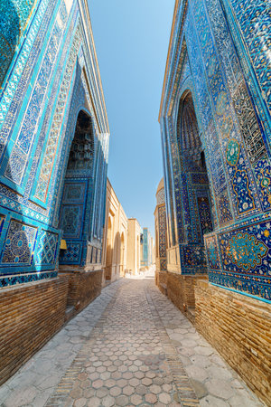 View of the Shah-i-Zinda Ensemble in Samarkand, Uzbekistan. Mausoleums decorated by blue tiles with designs. The necropolis is a popular tourist attraction of Central Asia.の写真素材