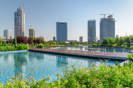 Awesome view of contemporary buildings reflected in pool of Tashkent City Park in Tashkent, Uzbekistan. The park is a popular recreational gathering place among residents and tourists.の写真素材