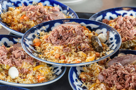 Fresh cooked wedding Uzbek plov in Tashkent, Uzbekistan. The signature dish of Uzbekistan is cooked with rice, meat, carrots and onions. Pilaf is a traditional food at Central Asia.の写真素材