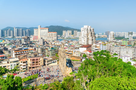 Amazing view of Macau on sunny day. The Ruins of St. Paul's are visible at the Historic Centre of Macao. Old and modern residential buildings. Macau is a popular tourist destination of Asia.の写真素材