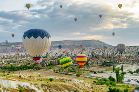 Awesome view of colorful hot air balloons flying over Goreme Historical National Park. Fabulous landscape of Cappadocia, Turkey.の写真素材
