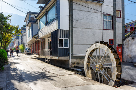 Dali, China - October 21, 2015: View of old house and water wheel at ancient city of Dali. Scenic street of Dali Old Town in autumn.の写真素材