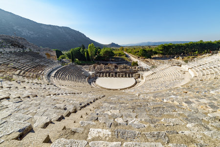 The Theatre of Ephesus (Efes) at Selcuk in Izmir Province, Turkey. The amphitheatre is the largest in the ancient world for gladiatorial combats and drama. Ephesus is a popular tourist destination.の写真素材