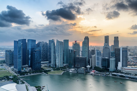 Awesome aerial view of Marina Bay and skyscrapers of downtown at sunset. Amazing Singapore skyline. Fantastic cityscape. Singapore is a popular tourist destination of Asia.の写真素材