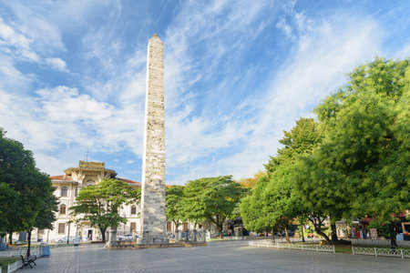 Awesome view of the Walled Obelisk (Constantine's Obelisk) in Sultanahmet Square of Istanbul, Turkey. Marmara University is visible in background. The roman monument is a popular tourist attraction.の写真素材