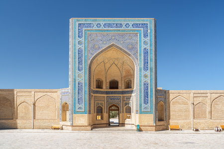 Awesome view of iwan entrance of the Kalan Mosque at Po-i-Kalan complex in Bukhara, Uzbekistan. Facade covered by glazed mosaic tiles. The ensemble is a popular tourist attraction of Central Asia.の写真素材