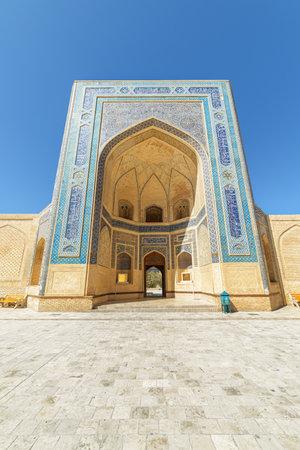 Awesome view of iwan entrance of the Kalan Mosque at Po-i-Kalan complex in Bukhara, Uzbekistan. Facade covered by glazed mosaic tiles. The ensemble is a popular tourist attraction of Central Asia.の写真素材