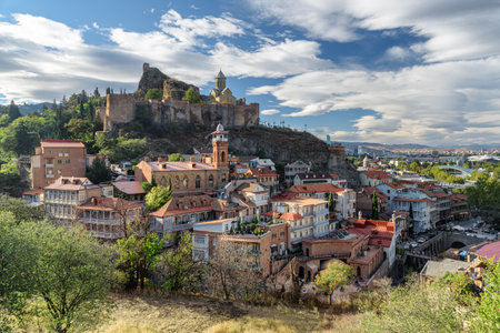 Awesome view of Old Town of Tbilisi, Georgia. Narikala Fortress with Saint Nicholas Orthodox Church is visible on blue sky background. Tbilisi is a popular tourist destination of the Caucasus region.の写真素材