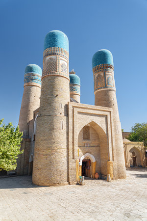 Awesome view of Chor Minor (the Madrasah of Khalif Niyaz-kul) in Bukhara, Uzbekistan. The historic gatehouse with four towers is a popular tourist attraction of Central Asia.の写真素材