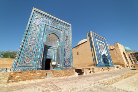 Awesome view of the Shah-i-Zinda Ensemble in Samarkand, Uzbekistan. Mausoleums decorated by blue tiles with designs. The necropolis is a popular tourist attraction of Central Asia.の写真素材