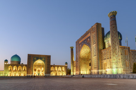Evening view of the Tilya-Kori Madrasah and the Sher-Dor Madrasah at the Registan Square in Samarkand, Uzbekistan. The Registan is a popular tourist attraction of Central Asia.の写真素材