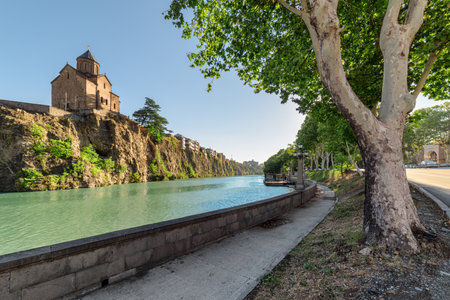 Awesome view of the Virgin Mary Assumption Church of Metekhi on the cliff over the Kura (Mtkvari) River in Tbilisi, Georgia. The Georgian Orthodox Christian church is a popular tourist attraction.の写真素材
