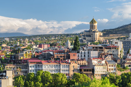 Awesome city view of Tbilisi, Georgia. The Holy Trinity Cathedral of Tbilisi (Sameba) is visible on blue sky background. The Sameba Cathedral is a popular tourist attraction of the Caucasus region.の写真素材