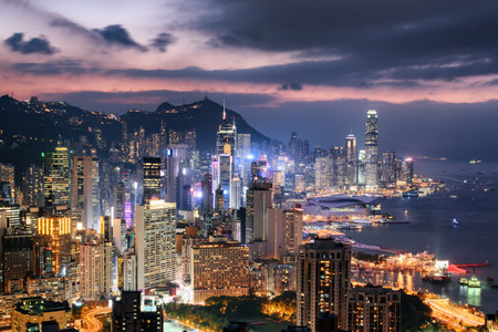 Unusual aerial view of skyscrapers in downtown of Hong Kong at sunset. Awesome cityscape. Hong Kong is a popular tourist destination of Asia.の写真素材
