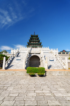 Awesome view of tower with blue tile roof of the National Folk Museum of Korea. Beautiful building of traditional Korean architecture at the Gyeongbokgung Palace area in Seoul, South Korea.のeditorial素材