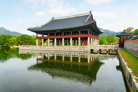 Gyeonghoeru Pavilion at Gyeongbokgung Palace in Seoul, South Korea. Sign "Royal Banquet Hall" on building of traditional Korean architecture. The pavilion reflected in water of artificial lake.のeditorial素材