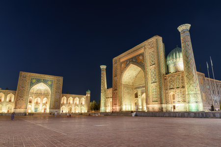 Evening view of the Tilya-Kori Madrasah and the Sher-Dor Madrasah at the Registan Square in Samarkand, Uzbekistan. The Registan is a popular tourist attraction of Central Asia.のeditorial素材