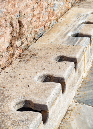 Scenic ruins of the latrines of Ephesus (Efes). Awesome view of public municipal toilets of the ancient Greek city at Izmir Province, Turkey. Ephesus is a popular tourist attraction in Turkey.のeditorial素材