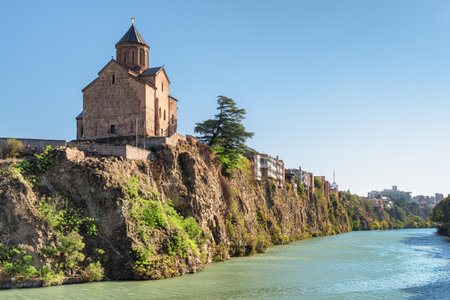 Awesome view of the Virgin Mary Assumption Church of Metekhi on the cliff over the Kura (Mtkvari) River in Tbilisi, Georgia. The Georgian Orthodox Christian church is a popular tourist attraction.の写真素材