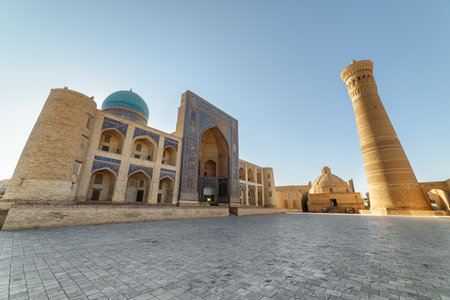 Part of Po-i-Kalan complex in Bukhara, Uzbekistan. Awesome view of the Mir-i-Arab Madrasa and the Kalan Minaret. The ensemble is a popular tourist attraction of Central Asia.の写真素材