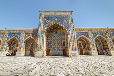 Awesome view of colorful arched niches at courtyard of the Tilya-Kori Madrasah (Tilla-Kari) at the Registan Square, Samarkand, Uzbekistan. The Registan is a popular tourist attraction of Central Asia.の写真素材