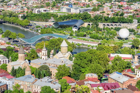Awesome city view of Tbilisi, Georgia. The Bridge of Peace over the Kura (Mtkvari) River and Center of perfoming arts are visible in the middle. Amazing cityscape.の写真素材