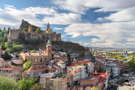 Awesome view of Old Town of Tbilisi, Georgia. Narikala Fortress with Saint Nicholas Orthodox Church is visible on blue sky background. Tbilisi is a popular tourist destination of the Caucasus region.の写真素材