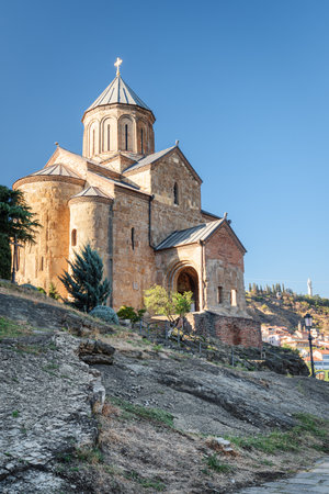 Awesome view of the Virgin Mary Assumption Church of Metekhi on the cliff over the Kura (Mtkvari) River in Tbilisi, Georgia. The Georgian Orthodox Christian church is a popular tourist attraction.の写真素材
