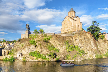 Awesome view of the Virgin Mary Assumption Church of Metekhi on the cliff over the Kura (Mtkvari) River in Tbilisi, Georgia. The Georgian Orthodox Christian church is a popular tourist attraction.の写真素材
