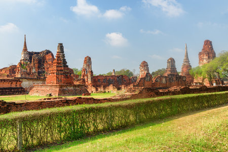 Scenic ruins of the Wat Mahathat in Ayutthaya, Thailand. Amazing view of the Buddhist temple in the ancient city and capital of the Ayutthaya Kingdom or Siam. Thailand is a popular tourist destinationの写真素材