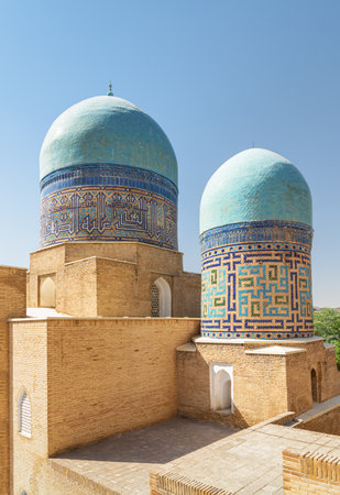 Awesome view of the Shah-i-Zinda Ensemble in Samarkand, Uzbekistan. Mausoleums decorated by blue tiles with designs. The necropolis is a popular tourist attraction of Central Asia.の写真素材