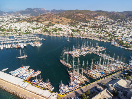Awesome aerial view of Bodrum Marina in Turkey. Yachts and boats are crossing Bodrum Harbor. The port city is a popular tourist destination in the Turkish Riviera.の写真素材