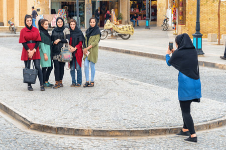 Yazd, Iran - 26 October, 2018: Young smiling pretty Iranian women taking pictures at the historical city of Yazd. Yazd is a popular tourist destination of the Middle East.のeditorial素材