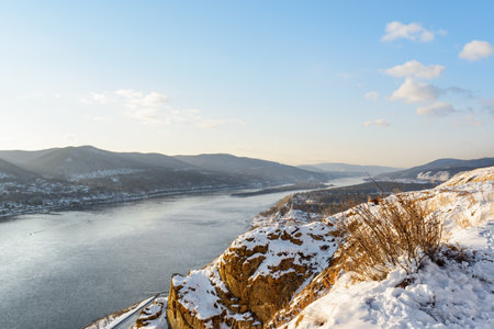 Awesome winter landscape. Top view of the Yenisey River among scenic mountains covered with snow, Siberia.の写真素材