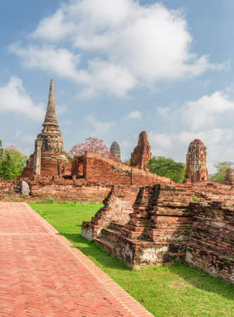 Scenic ruins of the Wat Mahathat in Ayutthaya, Thailand. Amazing view of the Buddhist temple in the ancient city and capital of the Ayutthaya Kingdom or Siam. Thailand is a popular tourist destinationの写真素材