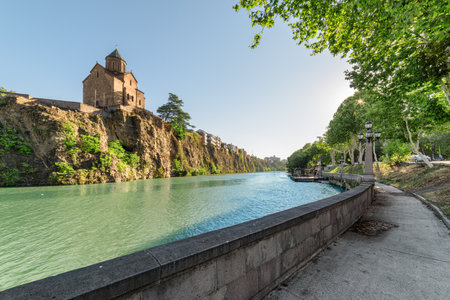 Awesome view of the Virgin Mary Assumption Church of Metekhi on the cliff over the Kura (Mtkvari) River in Tbilisi, Georgia. The Georgian Orthodox Christian church is a popular tourist attraction.の写真素材
