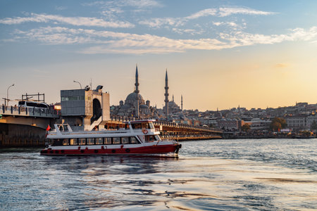 Scenic evening view of the Galata Bridge over the Golden Horn and the New Mosque (the Valide Sultan Mosque). Awesome Istanbul skyline.の写真素材